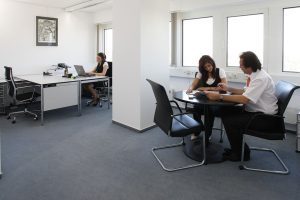 People talking at a desk in an office