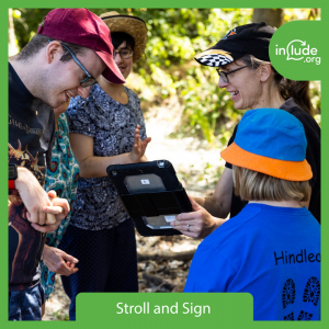 Alix and three members look at Pictello during Stroll and Sign wellbeing walk