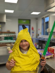 Girl holding a toy lightsabre