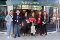 Members of the Include Choir standing outside Redhill Train Station