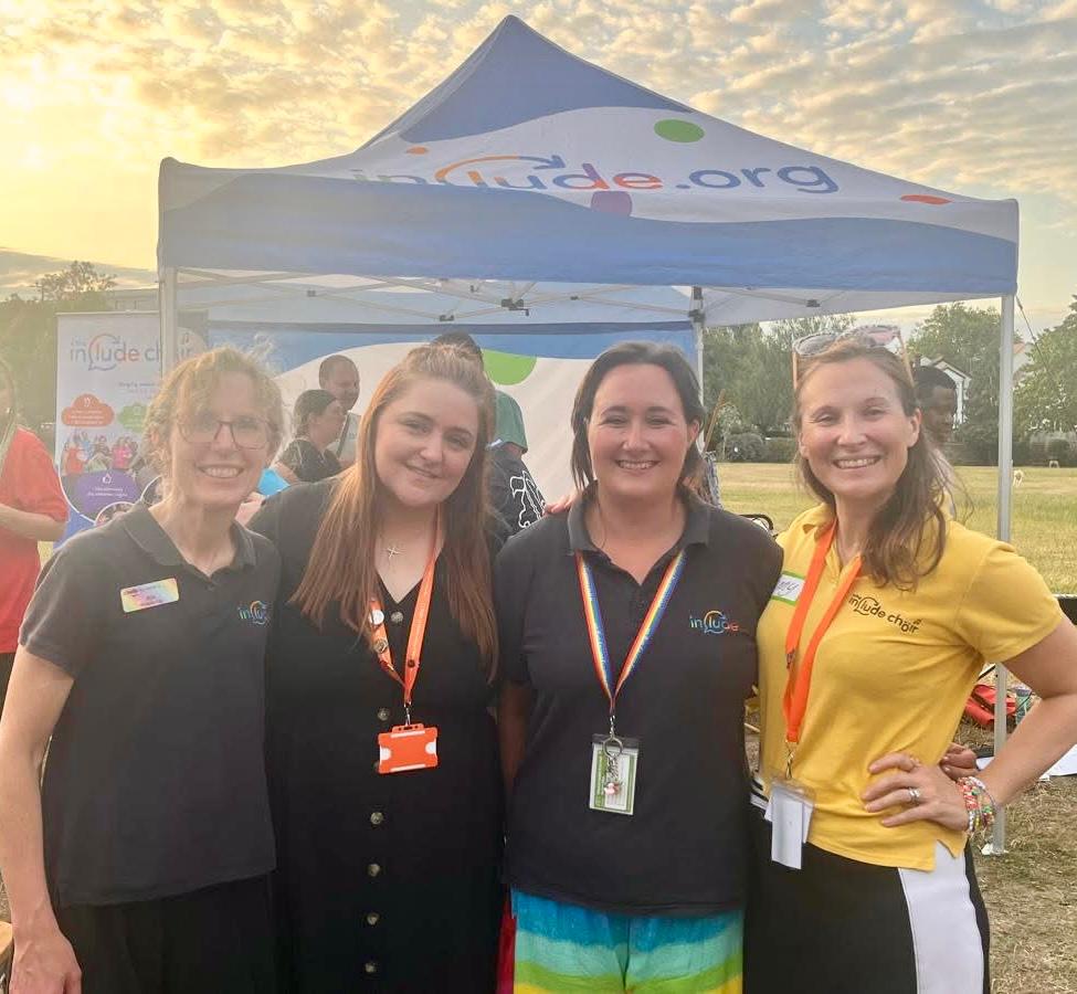 Members of Include staff and an event sponsor standing together outside after a performance