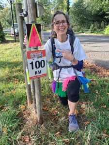 Alix happy to reach the rather small 100km sign!