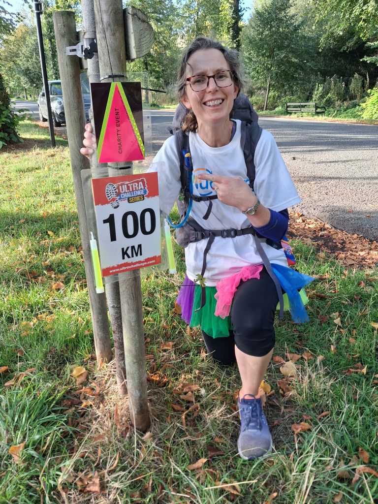 Alix happy to reach the rather small 100km sign!
