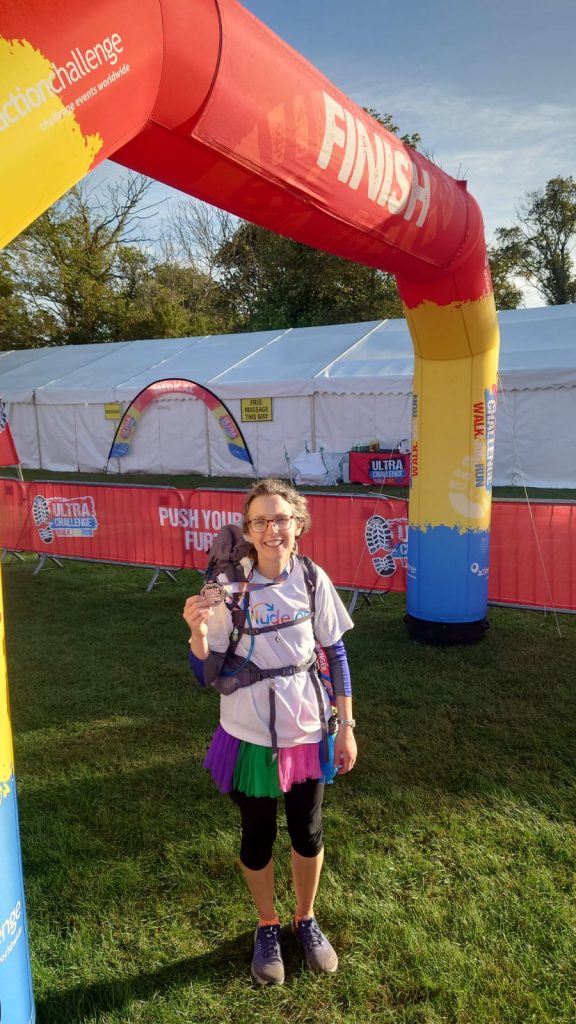 Alix at the finish line looking really proud holding her medal